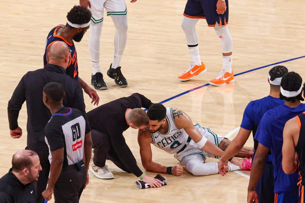 May 12, 2025; New York, New York, USA; Boston Celtics forward Jayson Tatum (0) with a member of the medical staff on the court after an injury in the second half during game four of the second round for the 2025 NBA Playoffs against the New York Knicks at Madison Square Garden. Tatum would leave the game with an injury after this play. Mandatory Credit: Vincent Carchietta-Imagn Images