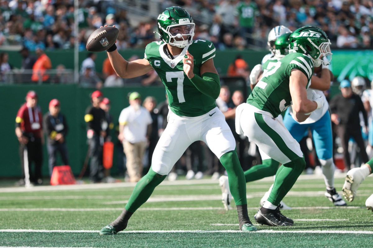 Oct 19, 2025; East Rutherford, New Jersey, USA; New York Jets quarterback Justin Fields (7) looks to get rid of the ball in the second quarter against the Carolina Panthers at MetLife Stadium. Mandatory Credit: Vincent Carchietta-Imagn Images