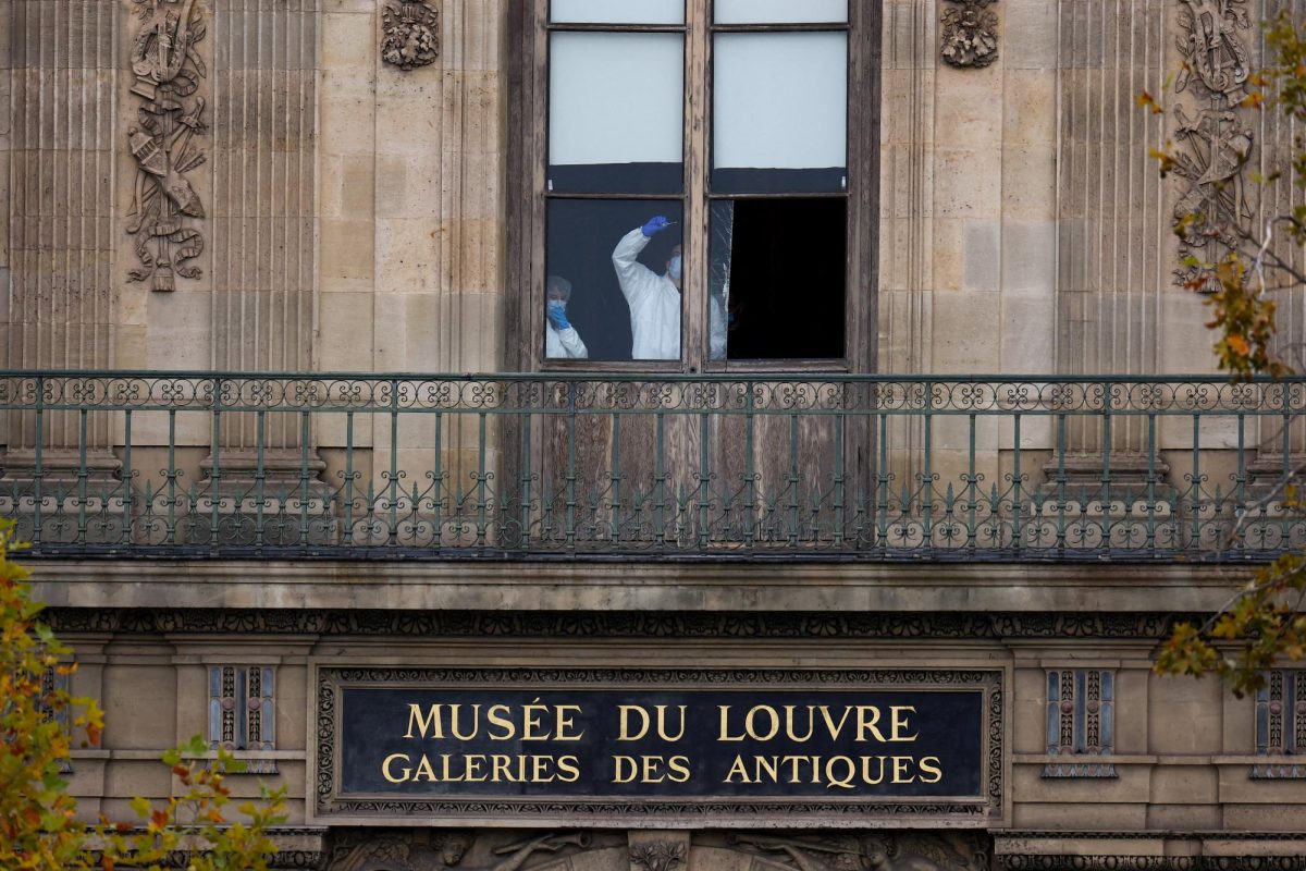 Members of a forensic team inspect a window believed to have been used in what the French Interior Ministry said was a robbery at the Louvre museum during which jewellery was stolen, in Paris, France. REUTERS/Gonzalo Fuentes