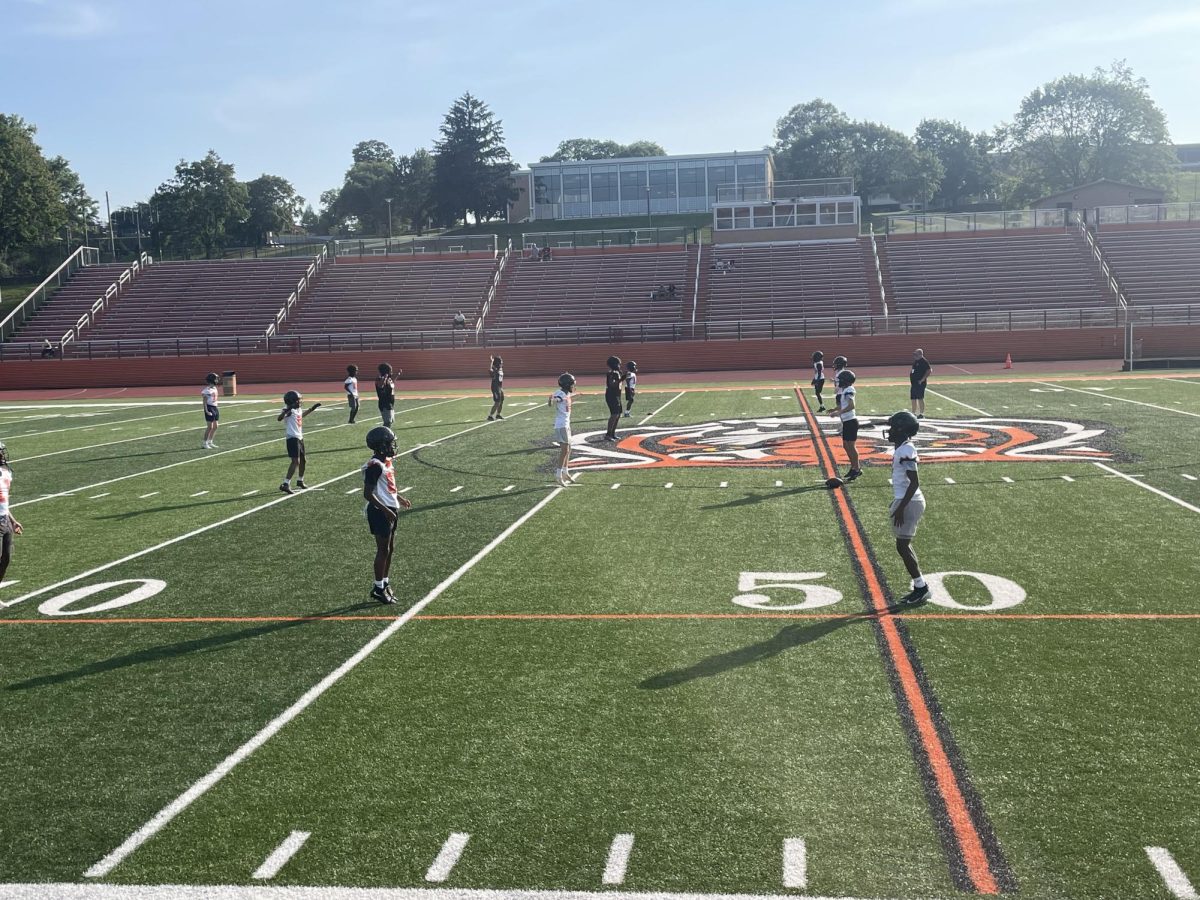 The Tigers warm up on their home turf before their preseason 7 on 7 workout 