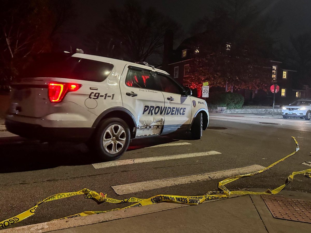 A police vehicle drives past police tape lying in the street after a shooting incident at Brown University in Providence, Rhode Island, U.S., December 13, 2025. REUTERS/Stringer