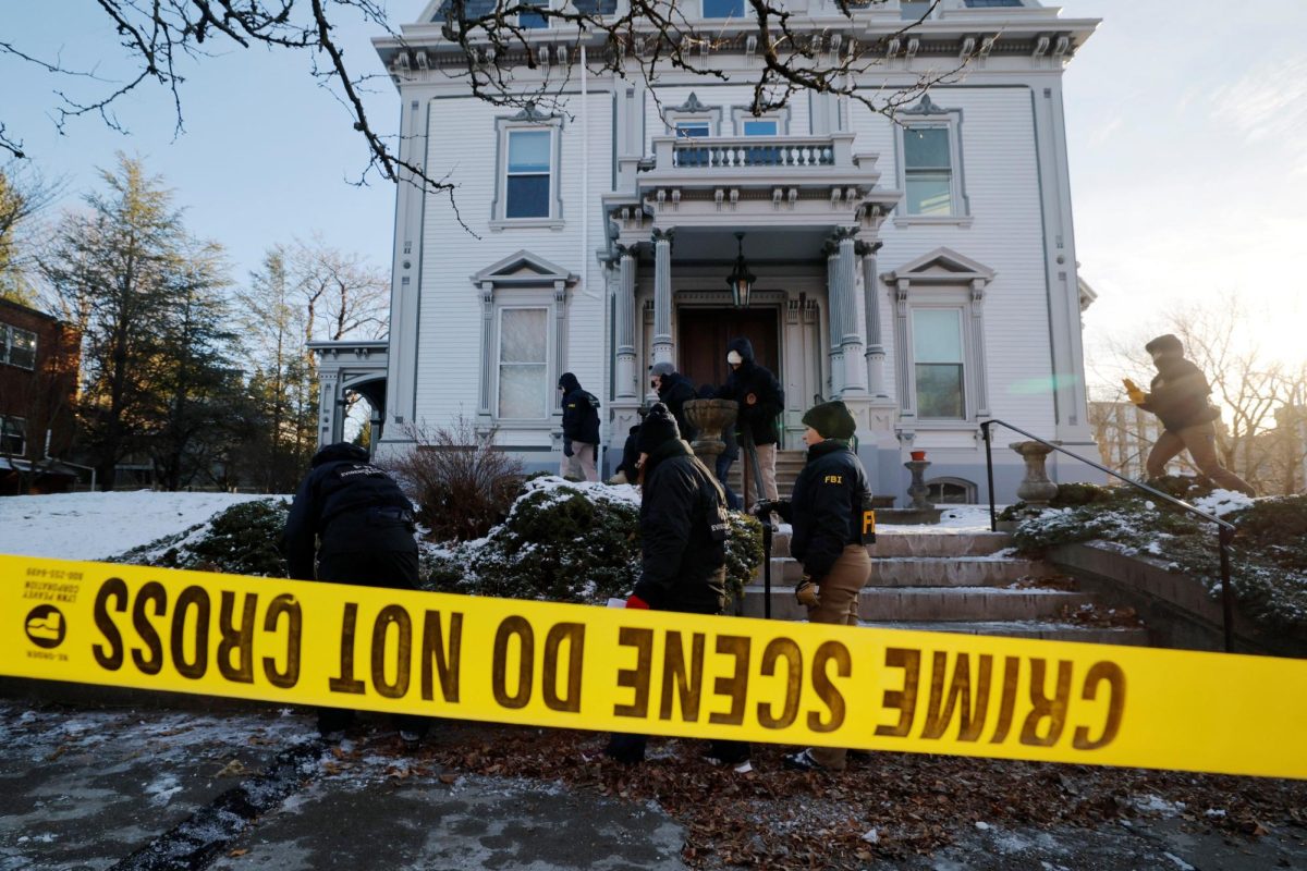 An FBI Evidence Response Team searches the grounds around the site of the Brown University shooting, as the manhunt continues for the gunman, in Providence, Rhode Island, U.S., December 15, 2025.   REUTERS/Brian Snyder